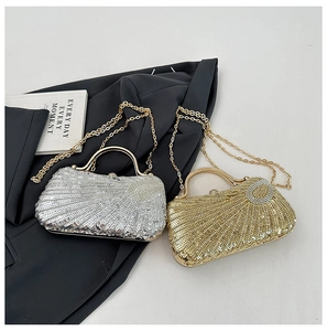 Close-up of gold and silver shell-shaped sequin evening bags with elegant metal chain straps