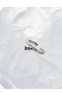 Macro view of S925 silver ring with irregular texture and purple rectangular zircon