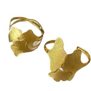 Minimalist golden ginkgo leaf open bracelet with white enamel inlay on white background