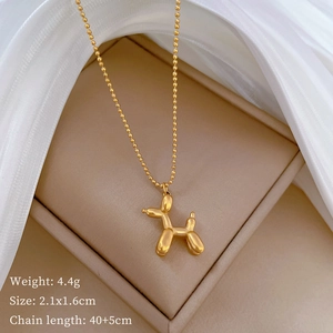 Detailed view of golden balloon dog pendant necklace with size and weight specifications