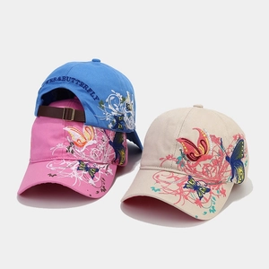Detail of sequined butterfly embroidery and adjustable leather strap on baseball caps