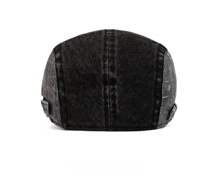 Rear view of washed denim flat cap showing metal side buckles and contrast stitching