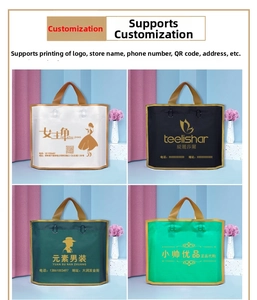 Close-up of frosted shopping bags in black, white, and green with gold handles
