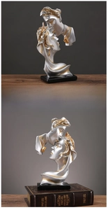Artistic silver and gold lovers kissing sculpture with a sleek black base for home decor