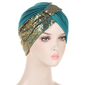 Deep green sequined turban for women featuring golden glitter patterns on a white background