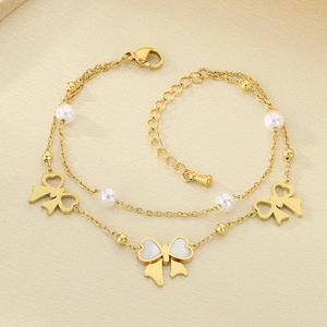 Detail of 18K gold-plated double-layer chain bracelet with bow charms and white pearls
