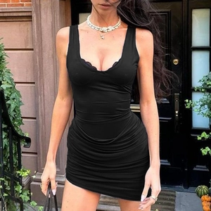 Detail of a black ruched mini dress with a deep U-neckline and tight sleeveless fit