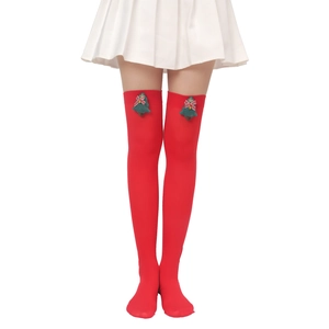 Detail of red Christmas over-knee socks with festive 3D tree decor and bow accents