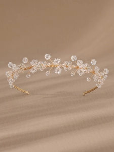 Close-up of golden bridal headband featuring handmade crystal flowers and rhinestone beads