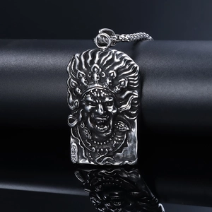 Detail of silver embossed stainless steel pendant with mythological figure on black pedestal