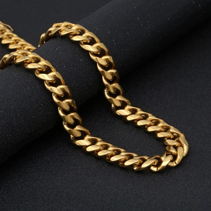 Men's fashion golden Cuban link chain in polished stainless steel on black background