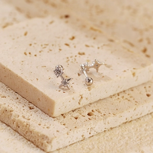 Detailed macro view of S925 silver star earrings with zircons and screw ball backings