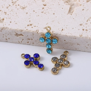 Gold plated stainless steel cross pendants with colorful rhinestones on a stone base