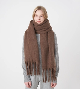 Detailed view of the thick brown mohair scarf with soft fringe and plush texture