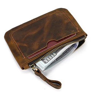 Detailed view of a brown vintage leather coin purse with cash and card slot features