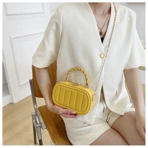 Fashionable bright yellow structured box bag with vertical stripes and gold chain strap