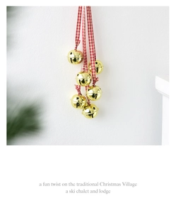 Detail of hanging gold star-cutout bells with red and white checkered ribbons