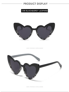 Detail view of heart-shaped sunglasses in C08 black and grey leopard print pattern