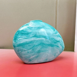 Detail of the marbled acrylic surface in lake green with an organic pebble shape