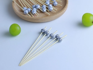 Detailed view of bamboo fruit picks with creative black and white football decoration