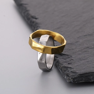 Detail of 316L stainless steel rings with irregular hammer texture in gold and silver