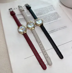 Three elegant leather watches with rhinestone-encrusted gold dials on a magazine page
