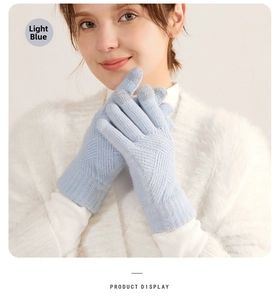 Detail of light blue winter knit glove showing the ribbed cuff and thick texture