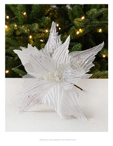 Macro view of white mesh Christmas flower with silver glitter on festive tree