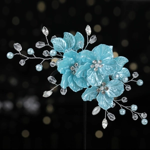 Detailed view of blue shell petals and crystal beads on handcrafted bridal hair clip