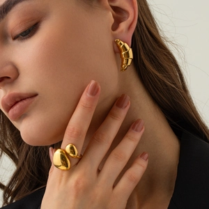 Chunky 18k gold plated stainless steel croissant earrings and irregular pebble ring on model