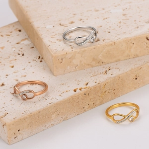 Three-piece infinity heart ring set in silver, gold, and rose gold with pavé stones
