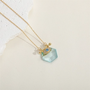Detailed close-up of a blue hexagon zircon pendant with a sparkling evil eye element