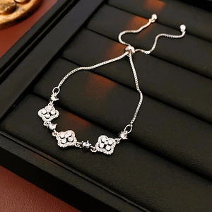 Detailed view of silver clover bracelet with zircon stones on professional display