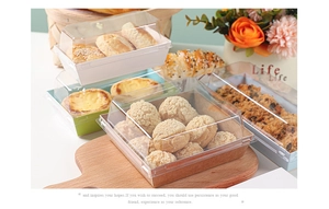 Clear plastic lids and paper bases for sandwich boxes shown in various pastel colors