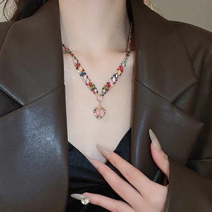 Close-up of heart-shaped pink zircon pendant on a multicolor gemstone necklace