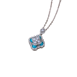 Silver flower pendant necklace with pearls and blue turquoise on a white background