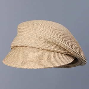 Detail showing high-quality raffia straw weaving texture on a light camel peaked sun cap