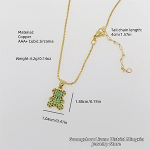 Detail showing green cubic zirconia bear pendant on 18K gold plated copper chain necklace