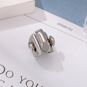 Minimalist silver geometric stainless steel ring presented on a white magazine background
