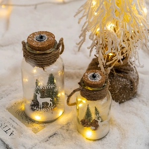 Nordic Christmas glass night light with LED tree and pinecone scene in warm glowing bottles