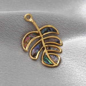 Golden leaf pendant with natural abalone shell inlay on elegant silk background
