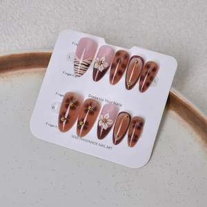 Detailed set of 10 almond press-on nails with leopard print and 3D floral accents