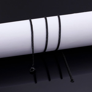 Macro view of black stainless steel Cuban link chain necklace with lobster clasp