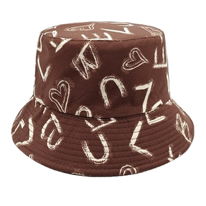 Detailed view of heart and letter graffiti print on a dark brown canvas bucket hat