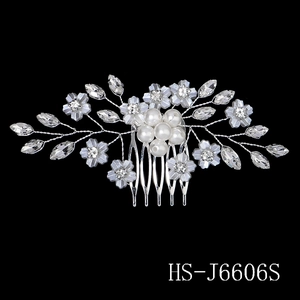 Macro detail of bridal hair comb with blue flowers, pearls, and crystals on silver wire