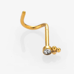 Macro shot of gold stainless steel nose stud with clear zircon and three bead detail