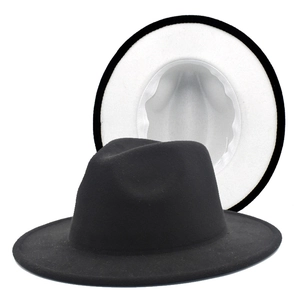 Detailed view of bicolor wool felt fedora showing black exterior and white interior lining