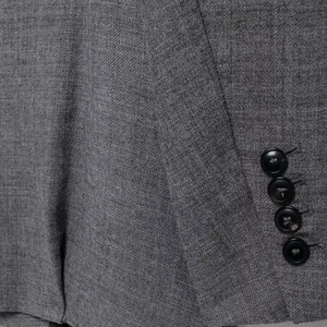 Retro grey oversized blazer with four black buttons and high-quality worsted fabric texture