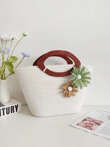 Handmade cream cotton rope woven tote with wooden handles and decorative floral accents