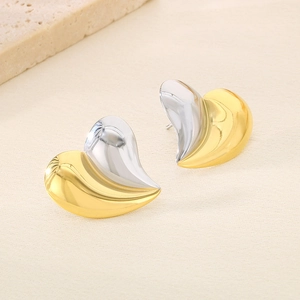 Détail de boucles d'oreilles en forme de cœur avec une finition bicolore or et argent